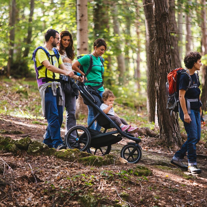 Family with trekking pushchair in Fai della Paganella. | © Fai Vacanze, 2019