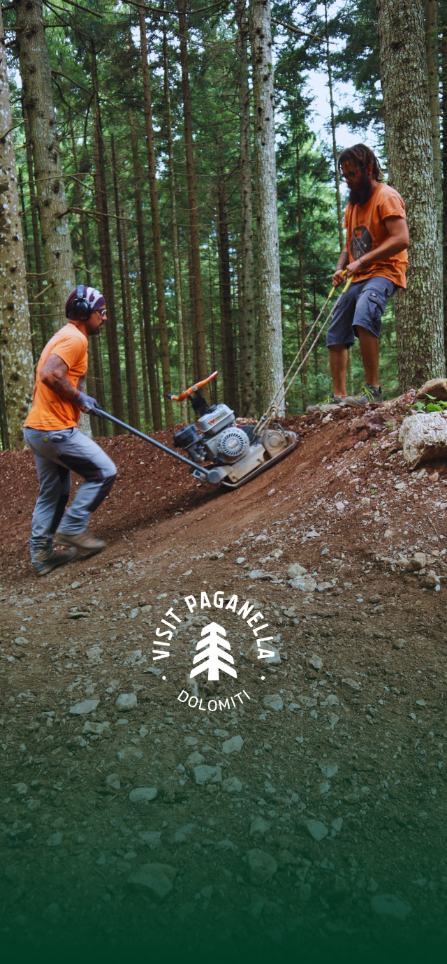 in the picture: a trail builders prepare the bottom of a trail with the help of a special machine. in the text: The birth of a trail. | © Filippo Frizzera, 2024